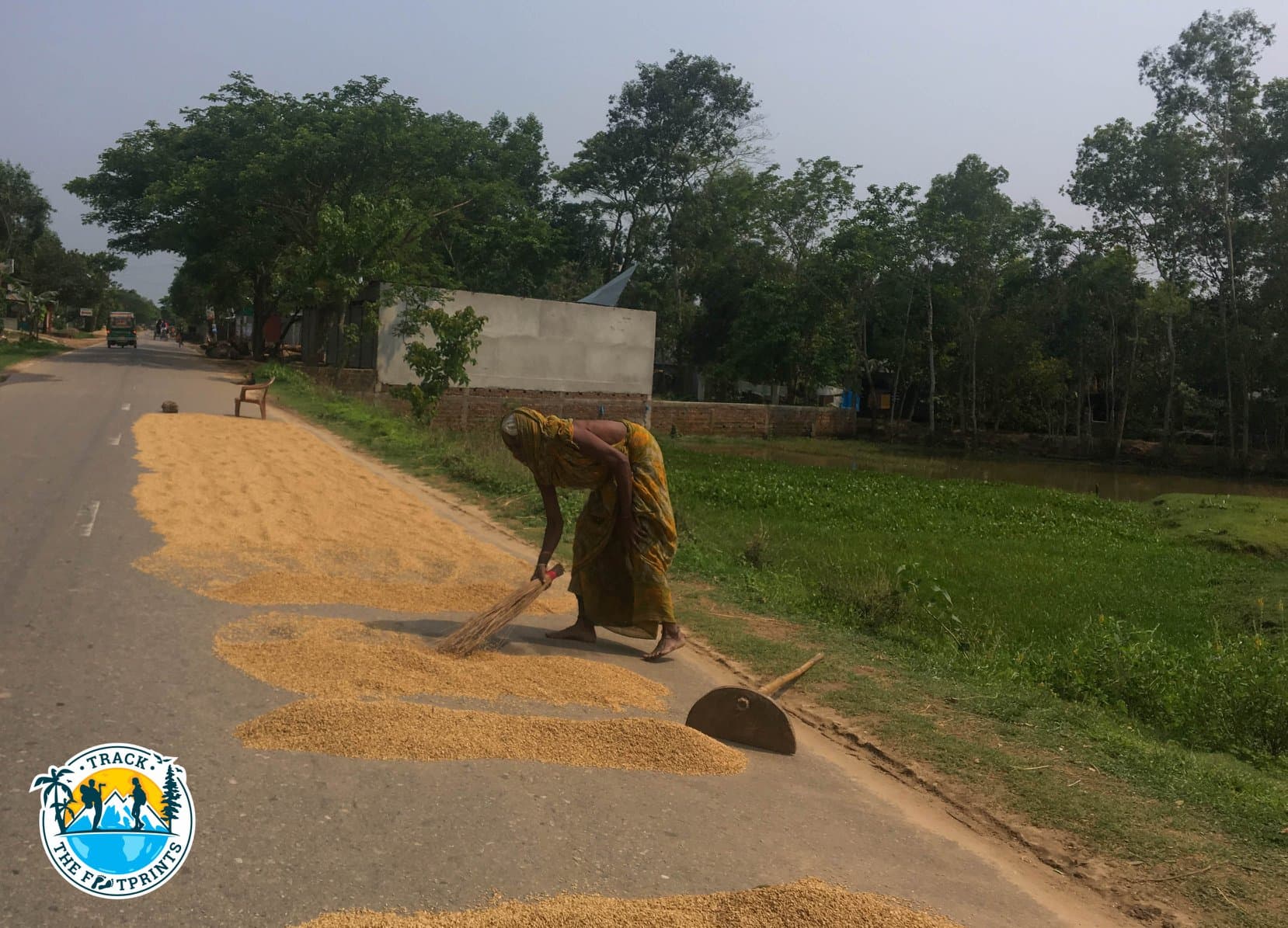 Close to the border, people is using the road for drying crops