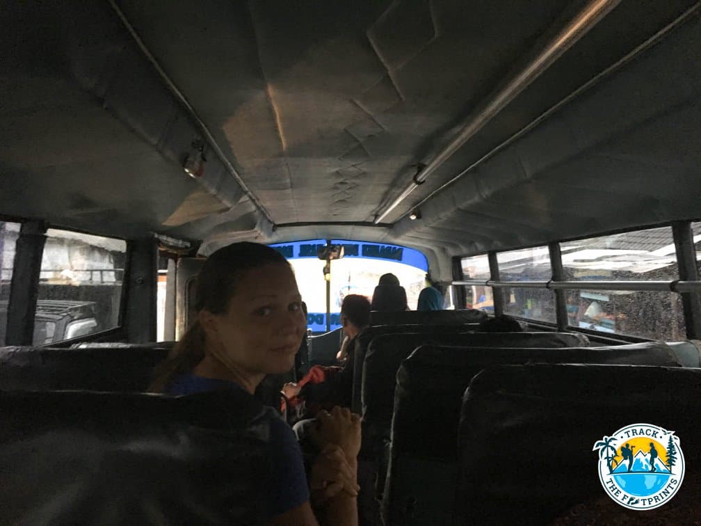 Augustina in the bus for Sape with a chicken next to her seat